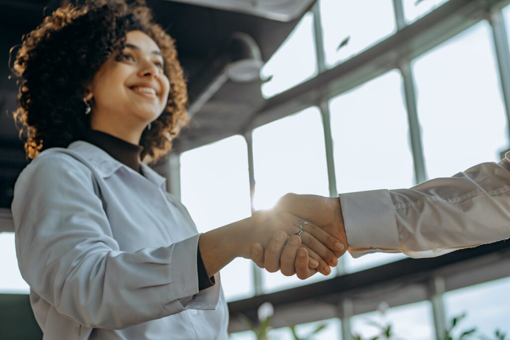 Woman shaking hand smiling